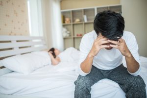 homem que sofre com disfunção erétil sentado na beira da cama e preocupada após não conseguir ter uma ejaculcação